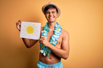 Tourist man on vacation wearing swimwear and hawaiian lei flowers holding banner with sun with a...