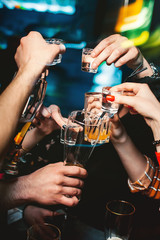 Close-up cheers clinking of friends with glasses in hands. Drink in party night.