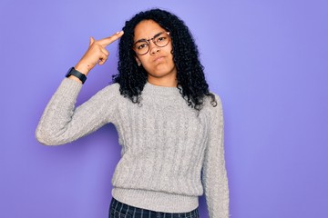 Young african american woman wearing casual sweater and glasses over purple background Shooting and killing oneself pointing hand and fingers to head like gun, suicide gesture.