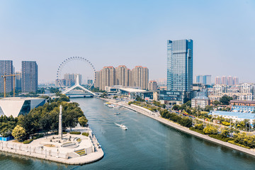 Obraz premium Twilight scenery of Haihe River and Ferris wheel in Tianjin, China 