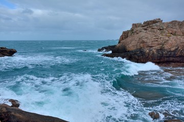 Beautiful view of the pink granite coast during storm in Brittany. France