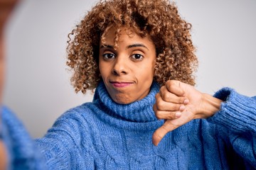 Young beautiful african american woman wearing turtleneck sweater making selfie by camera with...