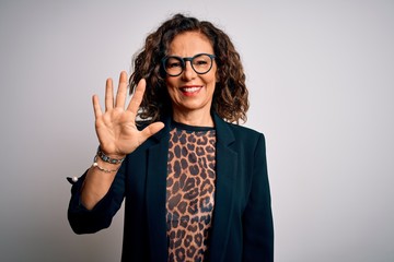 Middle age brunette business woman wearing glasses standing over isolated white background showing...