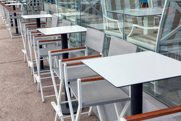 white tables of street terrace 