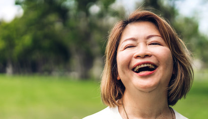 Portrait of happy senior adult elderly asian women smiling and looking at camera in the...