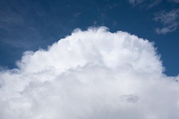 Puffy white clouds on a blue-sky day, as a nature background