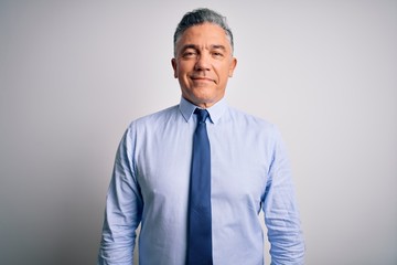 Middle age handsome grey-haired business man wearing elegant shirt and tie with a happy and cool smile on face. Lucky person.