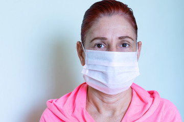 Adult woman with face mask on white background