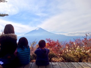 Family watching Mount Fuji and autumn leaves