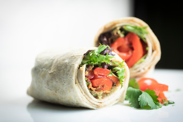 A fresh tasty California turkey wrap displayed on white platter