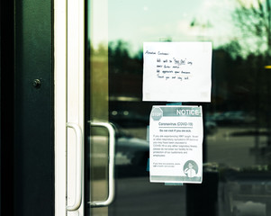Take-out only and Covid-19 health notices taped to restaurant door