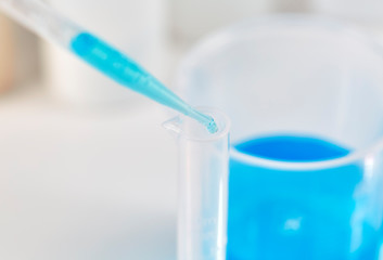 Blue Liquid dropping into a Test Tube