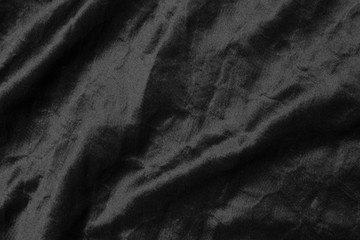 Abstract black fabric cloth texture background or liquid wave or wavy folds.