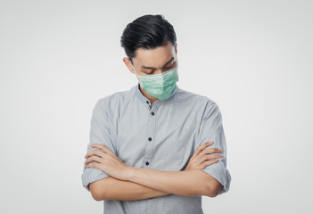 Young Asian Businessman wearing hygienic mask and looking down, Prevent infection, 2019-nCoV or coronavirus. Airborne respiratory illness such as pm 2.5 fighting and flu isolated on white background.