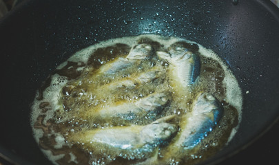 Fish fried in a black pan