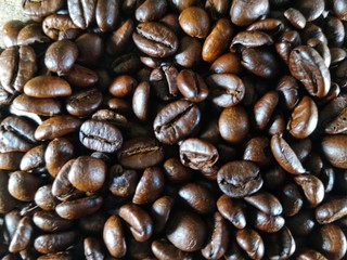 Coffee beans placed on a wooden background.