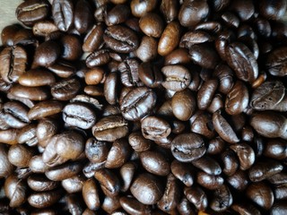 Coffee beans placed on a wooden background.
