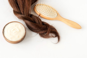 female hair, hair mask and bamboo comb on white background top view, flat lay. copy space. Self care concept.