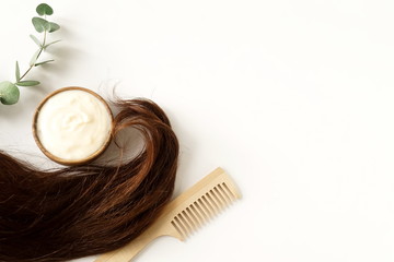 female hair, hair mask and bamboo comb on white background top view, flat lay. copy space. Self care concept.