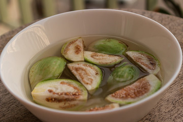 Thai vegetables. Eggplant on water in a white plate, ready to be used for cooking