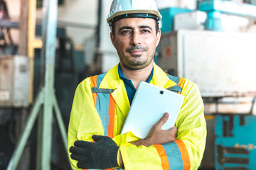 Industrial Engineers in Hard Hats.Work at the Heavy Industry Manufacturing Factory.industrial worker indoors in factory. man working in an industrial factory.Safty first concept.