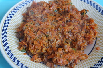 Top closeup view of a homemade dish made from carrot and vegetables.