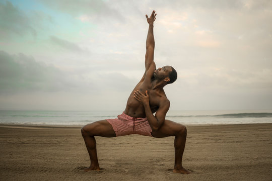 dance choreographer and dancer doing ballet beach workout - young attractive and athletic black African American man dancing outdoors doing beautiful performance