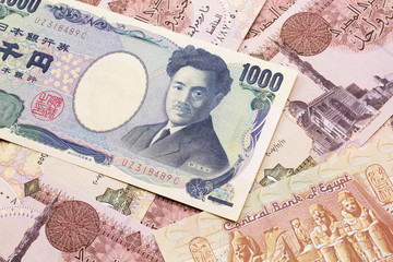 A one thousand Japanese yen bank note close up in macro with Egyptian one pound bank notes