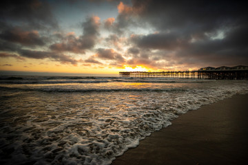Sunset over the Pier in Pacific Beach, California on a warm cloudy summer evening.