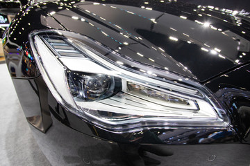 Close up front projector headlight of luxury sport car