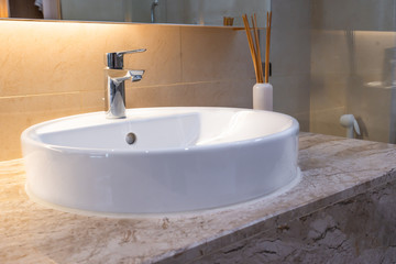 Modern faucet and white ceramic washbasin sink bathroom interior office building or home and living decoration