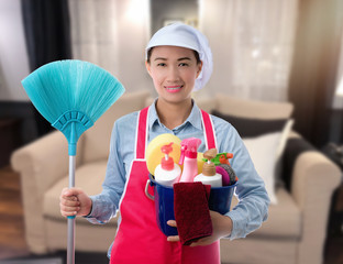 Woman with bucket ready to clean house on livingroom background background