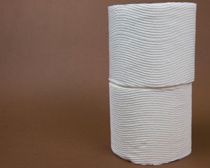 Toilet Paper Rolls Against a Brown Background