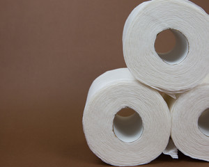 Toilet Paper Rolls Against a Brown Background