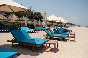 Deserted beach at the holiday resort with empty beach chairs due to the Corona Covid-19 virus