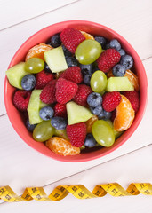 Fresh fruit salad and centimeter, healthy lifestyle and nutrition concept