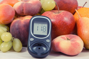 Glucose meter with result sugar level and fruits containing vitamins for healthy lifestyles of diabetics