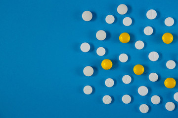 many white and red pills on a blue background