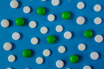 many white and red pills on a blue background