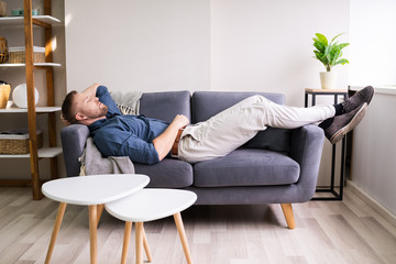 Tired Young Man On Couch
