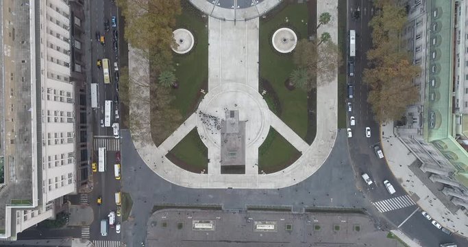 Aerial Drone Scene of May Square and Casa Rosada. The camera travels forward with a flaming flag. Landscape of the pyramid and pink house, historic building. Buenos Aires, Argentina