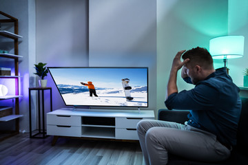 Man Looking At Falling Television