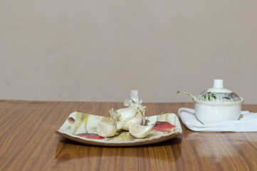 Garlic Salt on wooden table. Garlic salt is a seasoned salt made of a mixture of dried, ground garlic and table salt with an anti-caking agent ( calcium silicate)