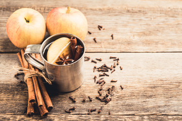 Apple cider in metal mug ont rustic background. Selective focus. Shallow depth of field.