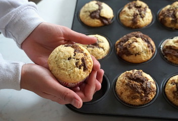 Baked muffin in woman hands. Tasty homemade muffin cakes