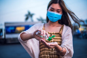 Asian women wear medical mask use antiseptic gel to protect Coronavirus or Covid-19 disease