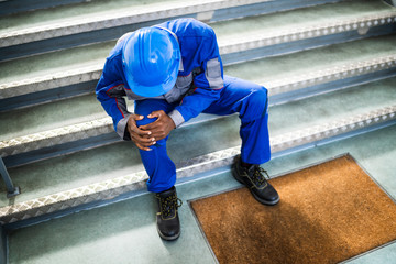 Handyman Sitting On Staircase