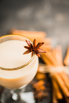 Tasty tea mith milk and spices on the rustic background. Selective focus. Shallow depth of field.