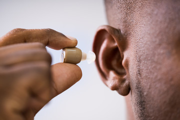 Male Hand With Hearing Aid