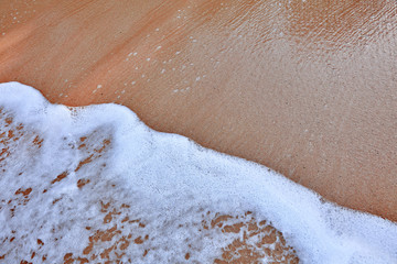 Wave On Sandy Beach. Background. Splash of waves on the sandy beach. foam, surf, waves.
